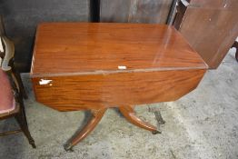 A 19th century mahogany pedestal Pembroke table, the turned column issuing acanthus carved downswept
