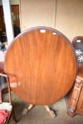 A Victorian mahogany oval loo table of traditional form, the base with turned and carved column