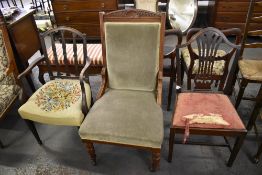 A Victorian walnut easychair with arched and carved crest rail and incised uprights, enclosing the