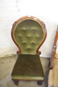 An unusual Victorian balloon back chair, the large spoon back with deep buttoned upholstery and