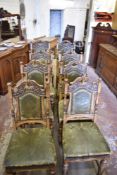 A set of eight Victorian carved oak leather upholstered dning chairs, having profusely stipple