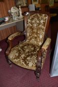 A Victorian walnut upholstered armchair, having a deep buttoned padded back and scrolled partially