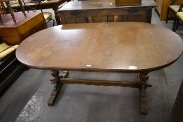 A 20th century oak extending dining table of rounded rectangular form with trestle style base 75 CM.