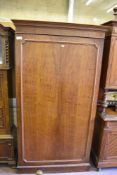 A continental mahogany armoire, the moulded panel door with re-entrant corners. 221CM X 122CM.