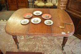 A Victorian mahogany extending dining table of rounded rectangular form with molded edge detail, all