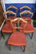 A set of five Victorian mahogany dining chairs, each having padded Serpentine seats raised on turned