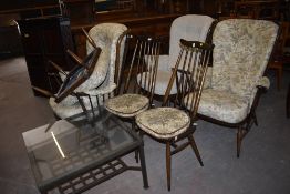 A group of three Ercol dark elm stick back lounge chairs, all together with a pair of Ercol dark elm