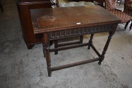 A Victorian oak foldover card table with swivel action and nulled frieze over turned supports, 76CM.