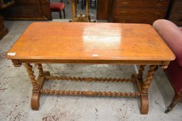 A Victorian light oak table of rounded rectangular form raised on barley twist supports. The