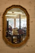 A 20th century gilt framed wall mirror, of canted rectangular form. 84CM.