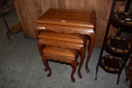 A nest of three modern imported wood tables of 19th century design. Largest. 65CM.