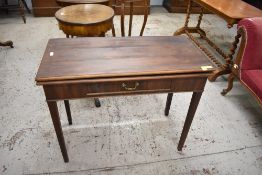 A George III mahogany fold over tea table, with gated supports to rear and single drawer to