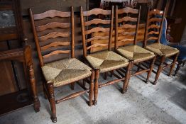 A set of four good quality reproduction oak rush seated ladderback chairs, Seat height. 48CM.
