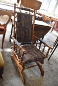 A Victorian turned satin wood American style rocking chair. Seat 38CM.