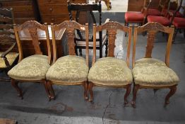 A set of four stipple carved late 19th century mahogany dining chairs, the arched top rails with