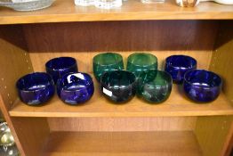 A group of nine coloured glass finger bowls, comprising five Bristol blue and four green glass.
