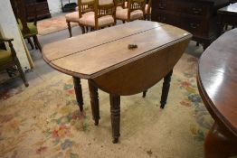An unusual 19th century oak extending dropleaf dining table, extending from the centre line and