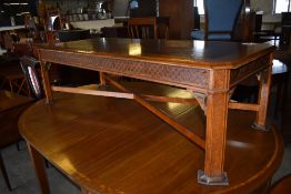 A Reproduction elm and mahogany rectangular coffee table, the canted top with quarter veneered