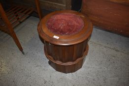 A Victorian mahogany commode, having a hinged and moulded circular top over a fluted cylindrical