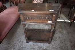 A reproduction oak credence table, of trapezoidal form with nulled detail to drawer 75CM.