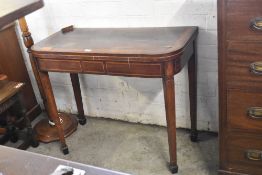 A George III banded mahogany fold over card table, having inlaid frieze and tapering square