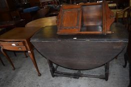 A 20th century reproduction drop leaf gateleg table sold together with a mahogany bureau,