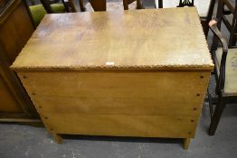 A modern light oak kist or coffer, of planked and studded construction with notched edge detail.