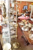 An arts and Crafts design brass telescopic standard lamp, having planished circular base with