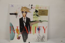 A David Bowie 'Reality ' MOV issue with 12 page book - NM - orange vinyl