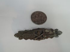 A GB 1935 Silver Crown along with a possible German WW2 Close Combat Clasp Badge