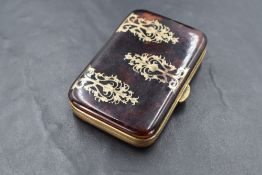 A late 19th century gilt metal and tortoiseshell purse, of hinged rectangular form with inset ornate
