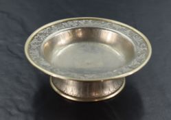 A Chinese white metal dish, of circular form with rolled rim and nicely engraved border enclosing