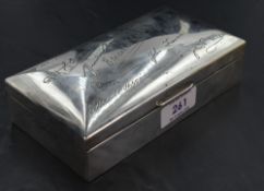 A George V silver cigarette box, of hinged and domed rectangular form, the cover engraved with