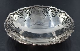 An Elizabeth II silver dish, of circular form with shaped outline and hand-pierced repeating foliate