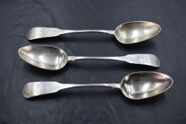 Three Queen Anne silver dessert spoons of fiddle back pattern having monogram to terminals and