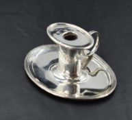 A George III silver 'Go to Bed' miniature chamber stick, of oval form with lift out broad rimmed