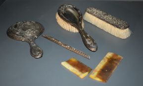 A group of three silver mounted dressing table wares, comprising hand mirror, hair brush, clothes