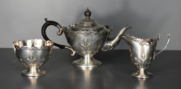 A George V silver bachelors three piece teaset, of tapering cylindrical form with strap-work