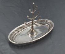 A George V silver ring stand, having a six branch central tree seated on an oval base with pierced