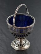 A George III silver sugar basket, having a bead moulded over handle over the bead moulded rim and