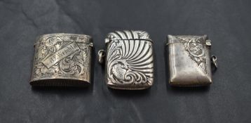 A group of three silver vesta cases, each of traditional design but smaller than normal proportions,