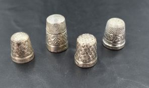 A group of four silver and white metal thimbles, two with English hallmarks, two marked Sterling,