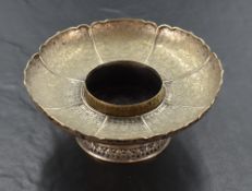 A Chinese white metal bowl, of lotus form with upturned petals engraved with repeating decoration