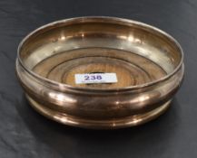 An Elizabeth II silver wine coaster, of moulded circular form, with turned mahogany base, marks