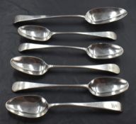 A group of five George III silver Old English pattern dessert spoons, each with Hanovarian