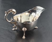 An early 20th century silver sauce boat, of traditional design with shaped rim and generous spout,