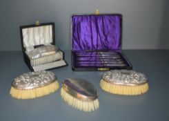 A 1940's cased silver backed clothes brush and comb set, each with engine-turned decoration, marks