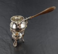 A Victorian silver toddy ladle and warming stand, the baluster ladle body with angular spout,
