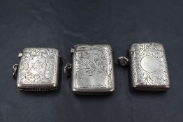 A group of three silver vesta cases, each with engraved foliate decoration, all Birmingham,