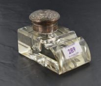 A late Victorian silver mounted clear glass ink stand, of rectangular wedge form with star-cut